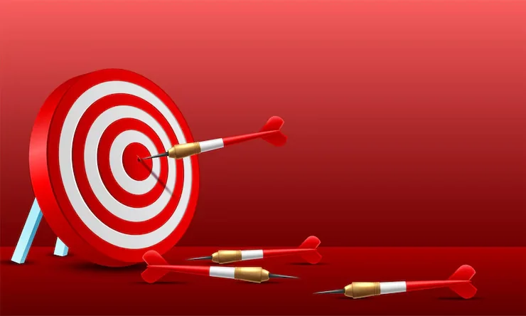 Red dart hitting the center target to represent business mission focus